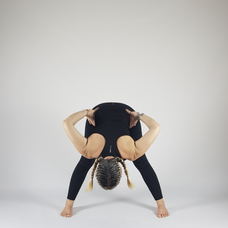 Wide-Legged Forward Fold Hands on Hips